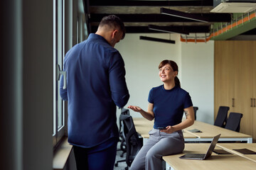 Obraz premium Professional Conversation Between Colleagues In A Modern Office With Laptop And Phone During A Casual Meeting Setup