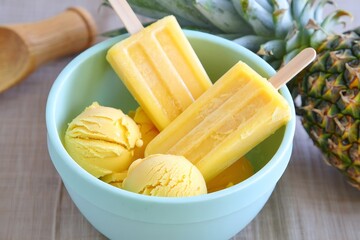 Yellow Popsicles and Ice Cream Scoop in a Turquoise Bowl.