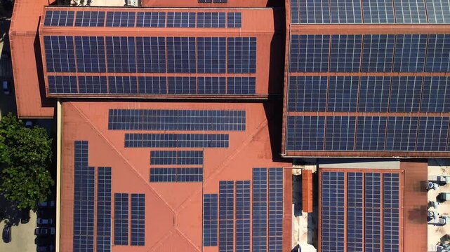 Straight-down drone shot of mall rooftop covered with solar panels in Puerto Princesa, Palawan, Philippines, illustrating urban renewable clean energy.