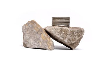 Balancing silver coins on rough stone financial concept