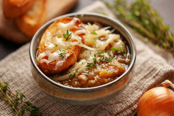 Classic French onion soup baked with cheese croutons sprinkled with fresh thyme.