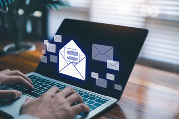 Hands typing on a laptop with glowing email icons, representing digital communication, email marketing, online messaging, business workflow, and modern technology solutions for corporate.