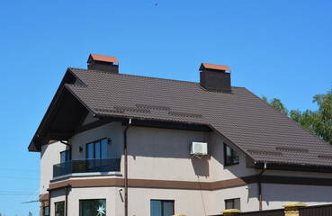 Modern House Facade with Metal Roof, Snow Guards, Balcony, Security Cameras and Air Conditioner