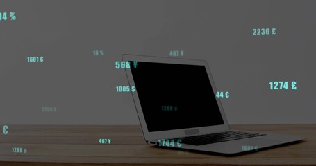 Displaying silver laptop partly open on wooden desk, teal numbers, currency symbols, copy space