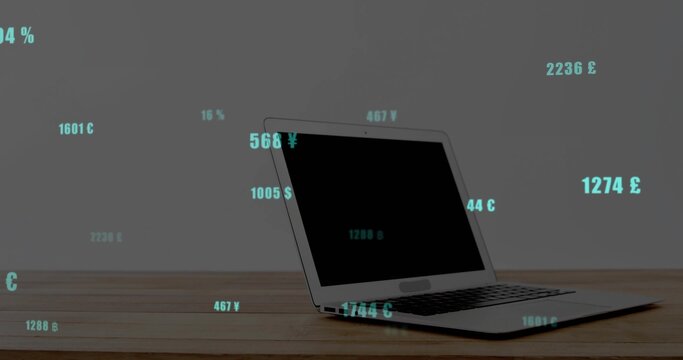 Displaying silver laptop partly open on wooden desk, teal numbers, currency symbols, copy space