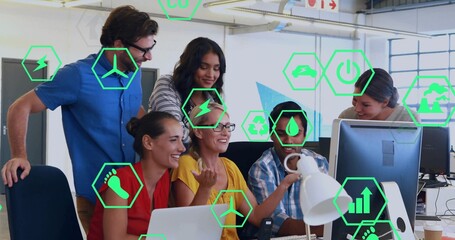 Gathering six coworkers at monitor and laptop in office in casual attire, showing green AR-icons