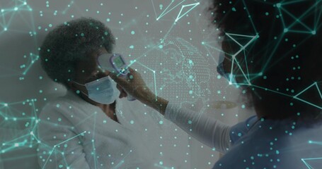 Checking senior patient masked, scrub nurse aiming IR temp gun in clinic, teal overlay, copy space