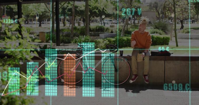 Orange-hoodie man checking phone on concrete ledge in park, bike and bag, data-overlay, copy space - Powered by Adobe