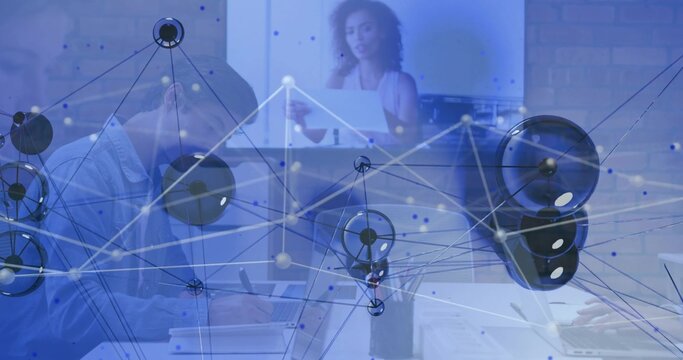 Presenting office team using laptops in meeting room, wearing business-casual with network overlay