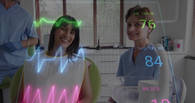 Smiling patient in white bib sitting in green dental chair at clinic blue-scrubbed staff vitals HUD - Powered by Adobe