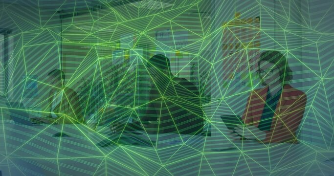 Collaborating, three colleagues in suits sitting at table with laptop, tablet and green overlay