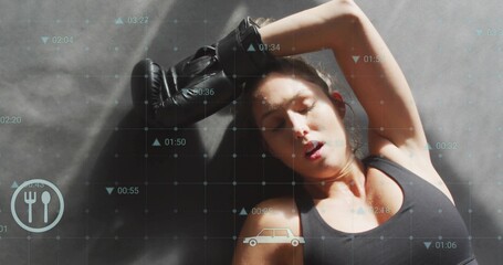 Lying woman resting on gym mat, wearing black bra and glove, grid showing fork-and-knife, car icons