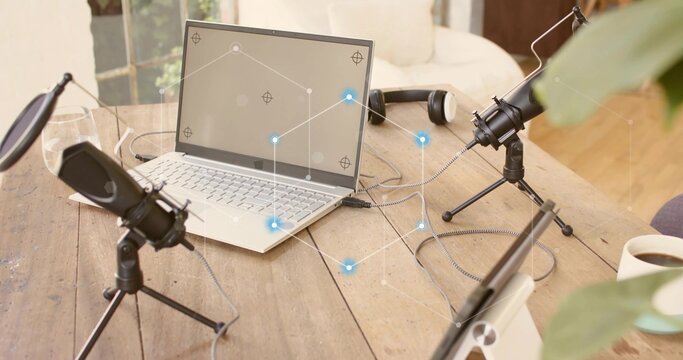 Showing podcast setup occupying center on wood table by window, with laptop and microphones - Powered by Adobe