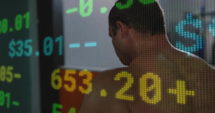 Turning adult male showing bare back and shoulders in office, displaying pixelated dollar numerals