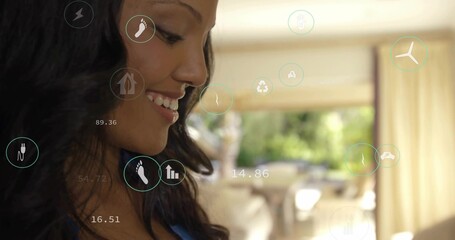 Smiling woman wearing blue top viewing AR overlays and numeric readouts in living area