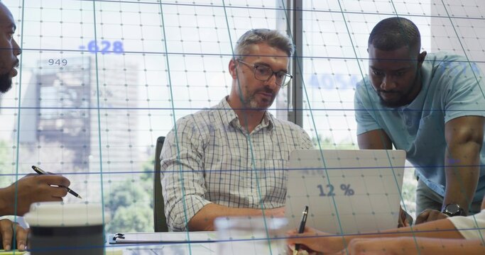 Leading man with glasses using laptop at meeting table, colleague in blue polo leaning, 12% overlay