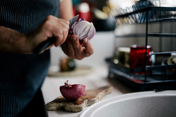 Cooking preparation with red onion slicing in a cozy kitchen