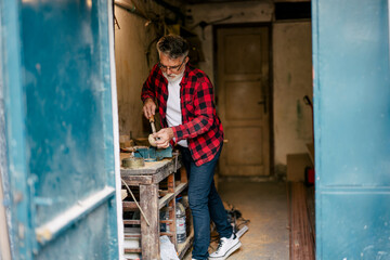 Craftsman working on a wooden project in a workshop
