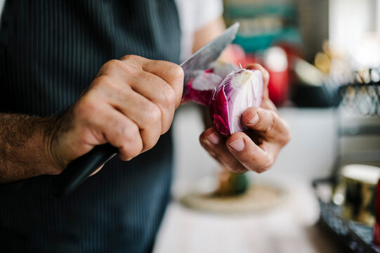 Chef skillfully prepares fresh vegetables in a modern kitchen