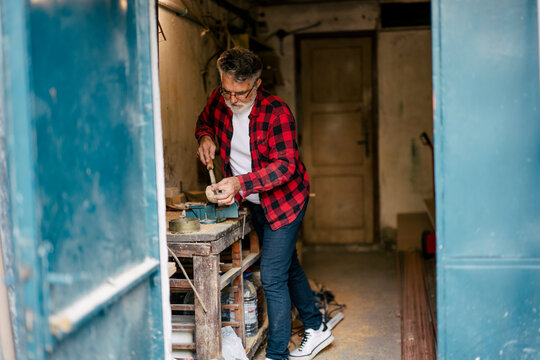 Craftsman working on a wooden project in a workshop - Powered by Adobe