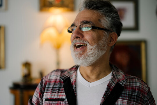 Elderly man smiling warmly at home