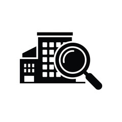 Magnifying glass over building icon for real estate search