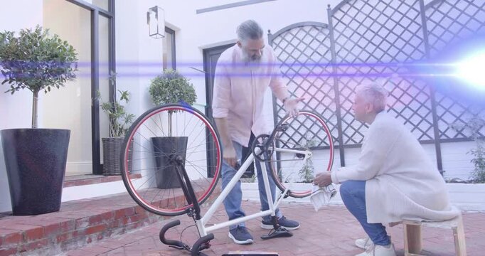 Man and woman DIY fixing upside-down bike exchanging wrench adjusting crankset preparing remount