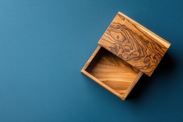 This image showcases a finely crafted wooden box with intricate patterns sitting on a smooth blue surface, highlighting the beauty of woodwork and design.