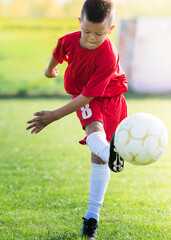Obraz premium Boy Shooting at Goal