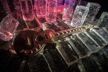 Music Concept: Guitar Miniature on a Dark Background with Vivid Light, Smoke, and Fire Effects. Golden electro guitar under a Dramatic Spotlight.