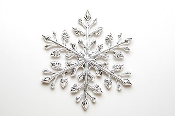 A shimmering silver snowflake decoration with intricate, delicate carved patterns.