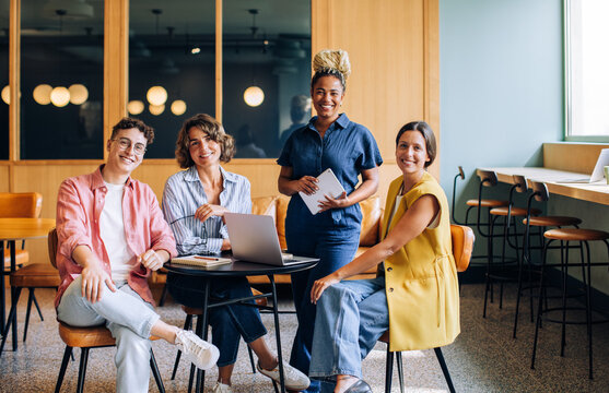 Diverse team of young professionals meeting at a modern workspace