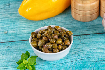 Pickled canned capers in the bowl