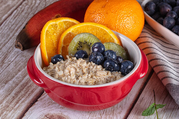 Oats porridge with blueberry, kiwi and orange