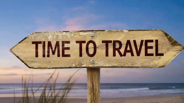 Weathered Wooden Arrow Sign &lsquo;TIME TO TRAVEL&rsquo; on Beach  Sunset Sky, Ocean Waves, and Grass, Nostalgic Vacation Concept
