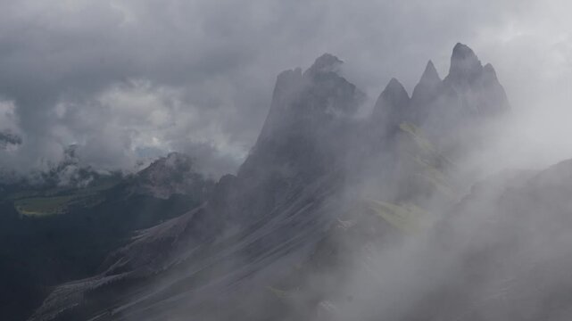 Seceda Ridge with Fog over Green Alpine Slopes in the Dolomites in Italy