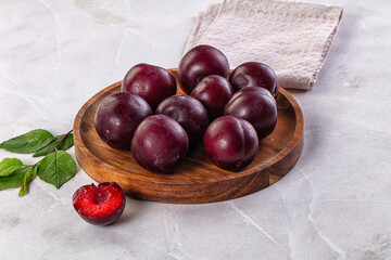 Raw ripe purple plum heap