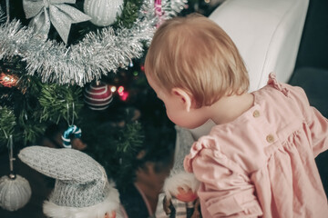 Toddler Examining Christmas Ornaments
