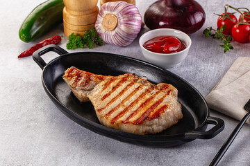 Tasty hot grilled bone steak served sauce