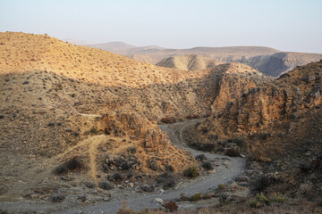 A canyon in the desert. Bare mountains and a canyon. Beautiful nature like on planet Mars. The rocky walls of the canyon are high. Mountain landscape
