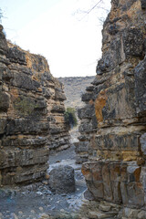 A canyon in the desert. Bare mountains and a canyon. Beautiful nature like on planet Mars. The rocky walls of the canyon are high. Mountain landscape