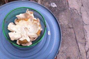 Dried Mushroom Pieces in Green Strainer on Circular Blue Container Outdoor Culinary Ingredients Capture