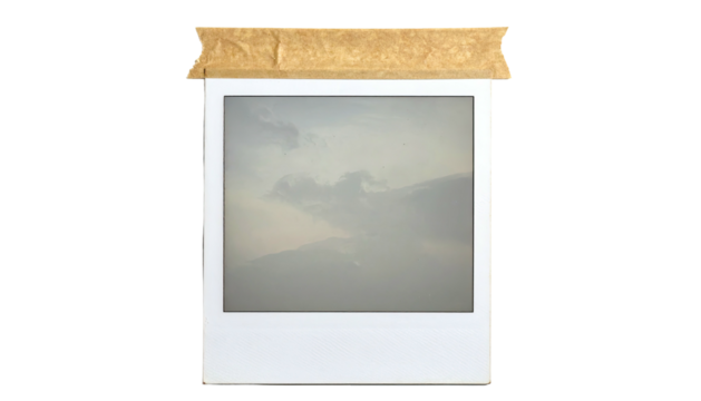Square photo print depicting cloudy skies taped to black backdrop