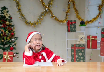 Happy a little girl with Xmas morning in decorated living room.Christmas