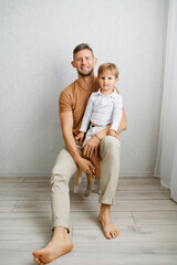 Father Holding Son Sitting On Lap Together