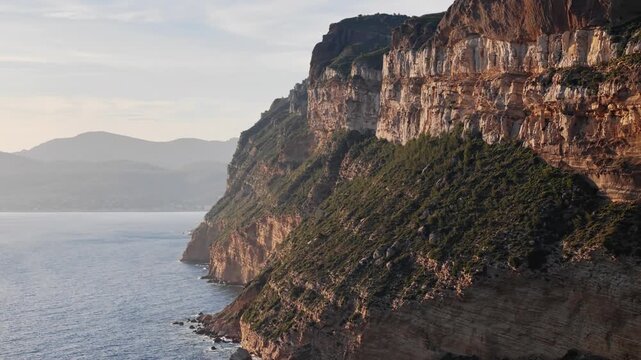 Massive cliffs of Cap Canaille on shore Mediterranean Sea near Cassis, Southern France. Aerial view from offshore