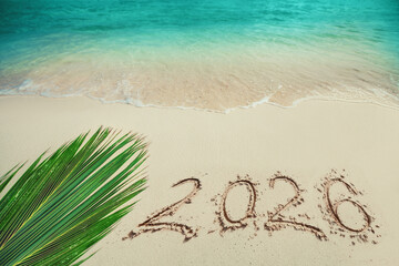 Holiday background  happy new year 2026 on sea sand blue ocean wave on tropical beach 