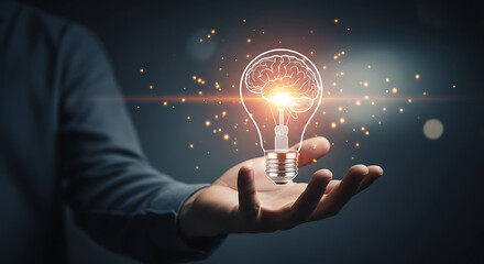 A hand holding a lightbulb with a brain inside symbolizing creative ideas and innovation process