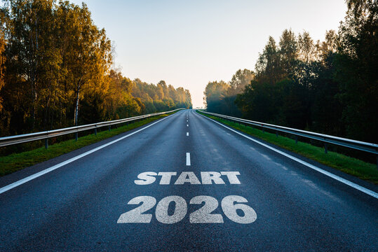 New year 2026 start or goal concept. Text 2026, written on the road in the middle of asphalt road with at sunset. Concept of planning, goal, challenge, new year.