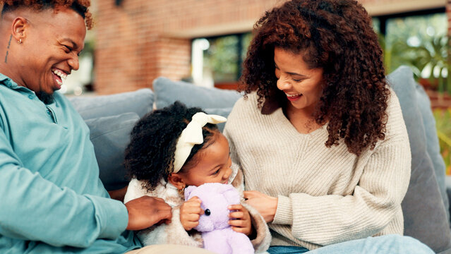 Happy family, playing or child with teddy bear on sofa for bonding, laughter or interaction in home. Mom, dad and tickling with kid or daughter for playful childhood or affection together in house